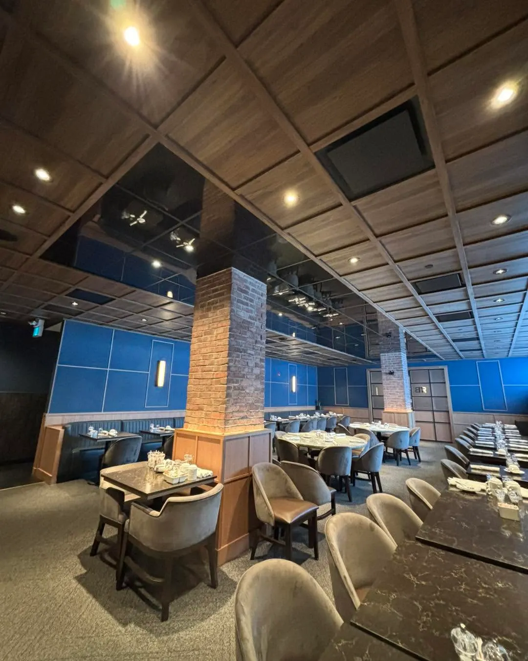 Dining room with recessed downlights, cove lighting and track heads over the banquettes