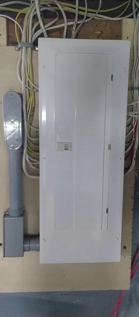 Replacement residential electrical panel installed in a utility space